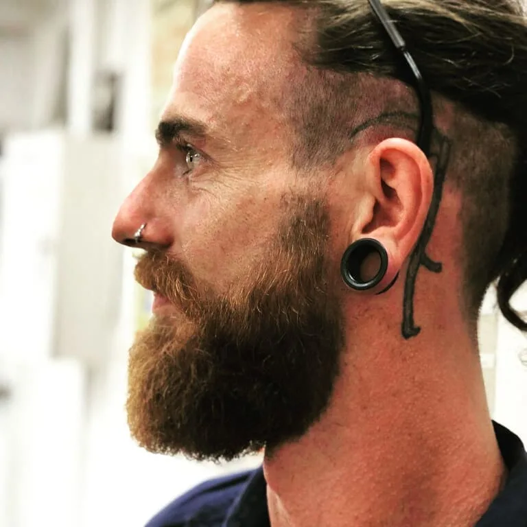Man with long ginger beard, profile