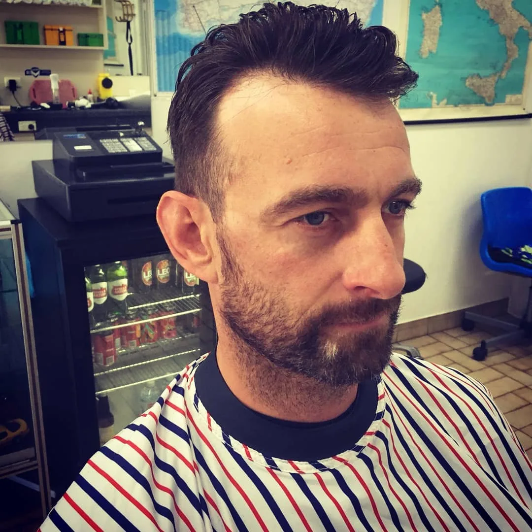 Man with textured quiff and stubble, map of Italy behind